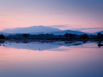 Scenic view of lake against romantic sky at sunset