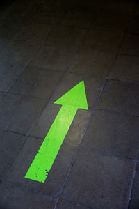 High angle view of arrow sign on road