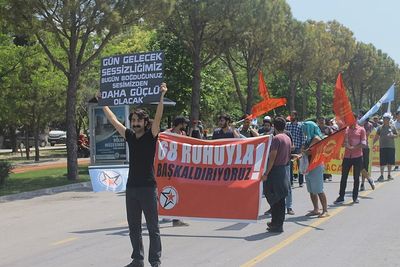 People on street against trees in city