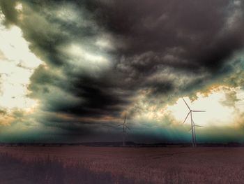 Scenic view of field against dramatic sky