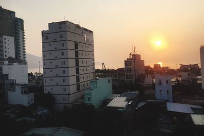 Buildings in city at sunset