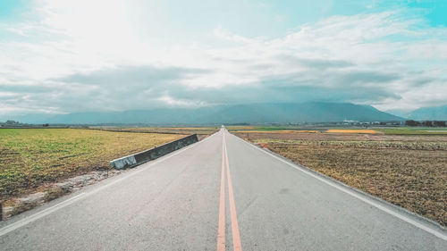 Empty road along landscape