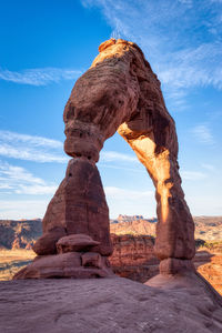 Delicate arch in arches national park in the day with blue skies.