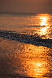 Scenic view of beach against sky during sunset