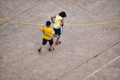 High angle view of men playing with umbrella