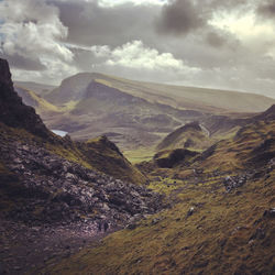 Scenic view of mountains against cloudy sky