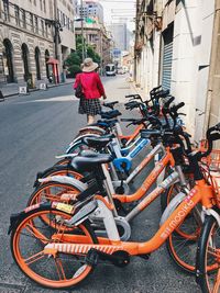 Rear view of man and bicycle on street against building