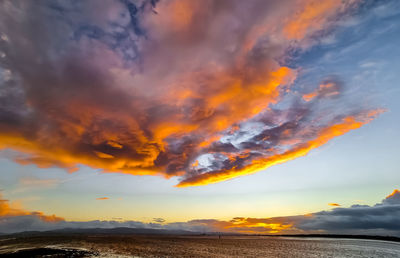 Scenic view of dramatic sky over land