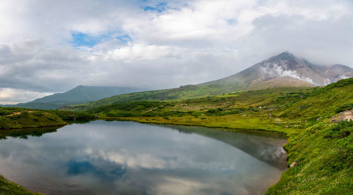 Scenic view of lake and mountains against sky