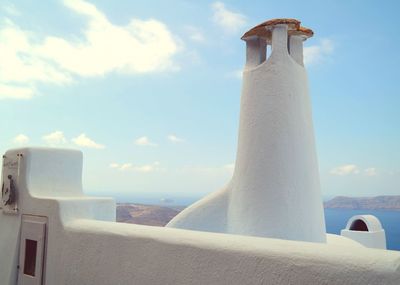 Lighthouse against cloudy sky