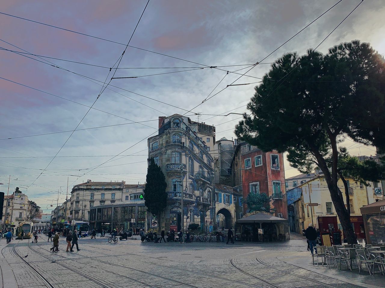 PEOPLE WALKING ON STREET IN CITY AGAINST SKY