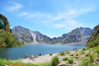 Scenic view of lake and mountains against sky