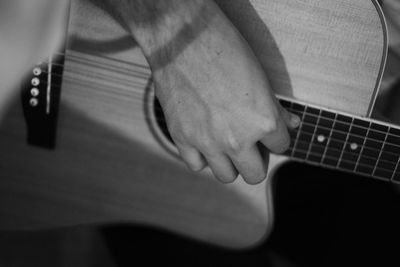 Close-up of man playing guitar