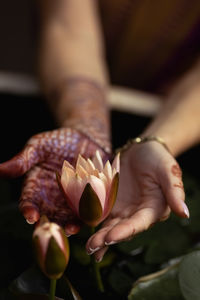 Mehndi adorns the women's hands with a beautiful flower design.vesak day