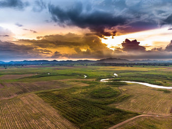 Scenic view of field against sky during sunset