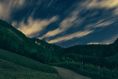 Scenic view of mountains against sky at night