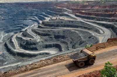 High angle view of construction vehicle moving on road at open-pit mine