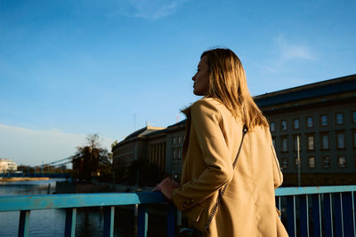 Cheerful woman walks at europe city street