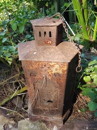 Close-up of old rusty metal on field