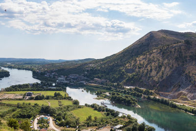 Scenic view of lake and mountains against sky