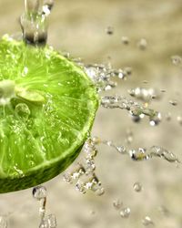 Close-up of water falling on halved lime