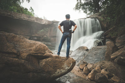 Rear view of man standing on rock