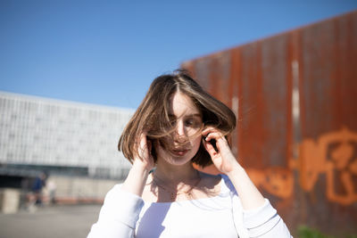 Portrait of beautiful woman against sky