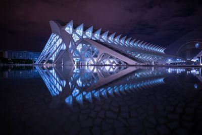 Reflection of illuminated building in water at night