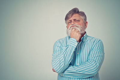 Midsection of man standing against gray background