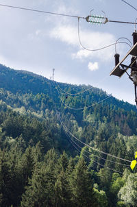 Low angle view of ski lift against sky