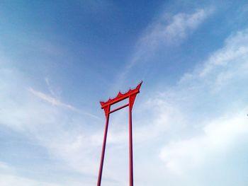 Low angle view of red flag against sky