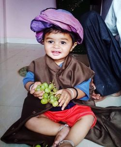 Portrait of cute boy sitting at home