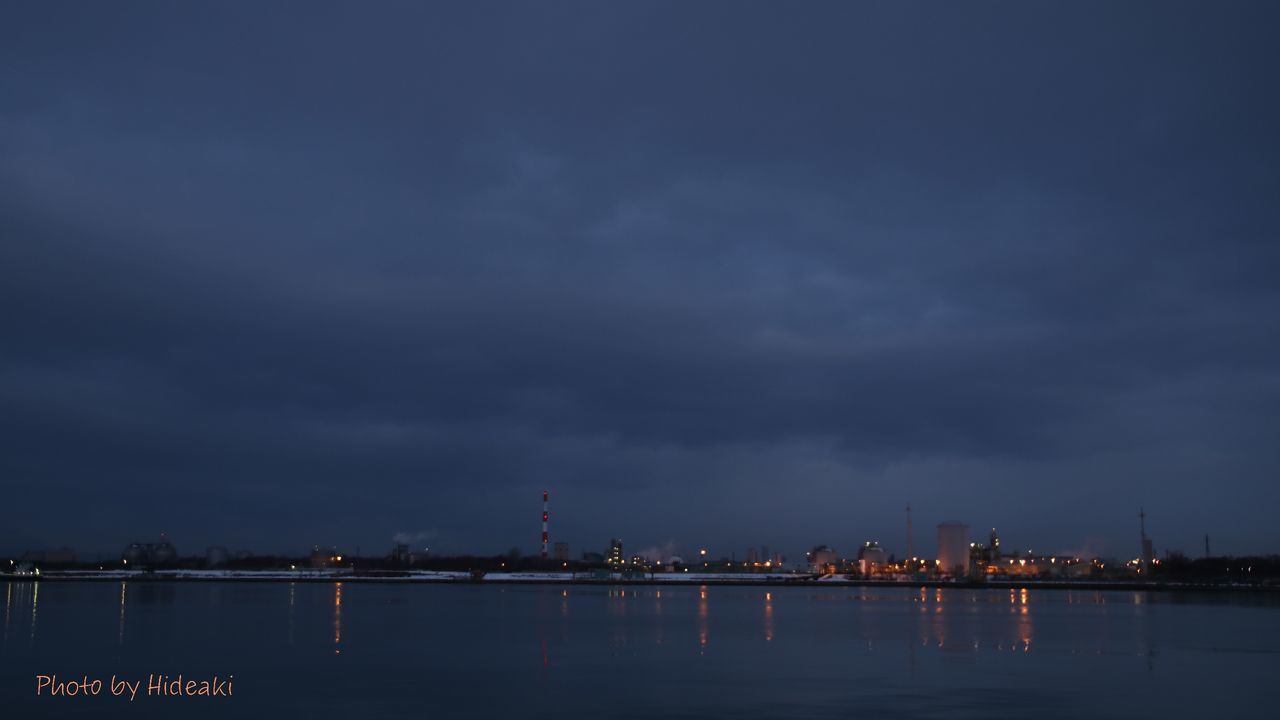 water, illuminated, waterfront, sky, night, cloud - sky, sea, dusk, built structure, river, architecture, building exterior, scenics, reflection, tranquility, nature, beauty in nature, cloudy, city, tranquil scene