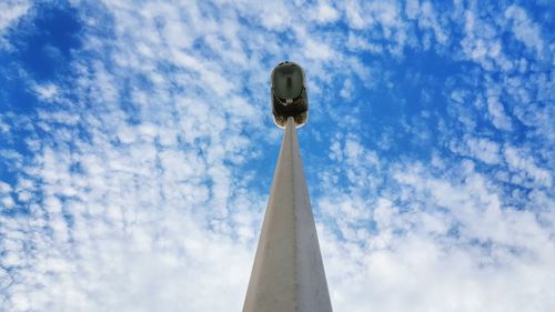 Low angle view of lamp post against clouds