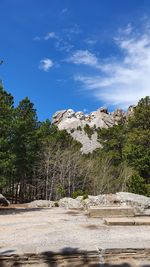 Trees and rocks against blue sky, mount rushmore