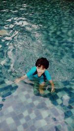 High angle view of boy swimming in pool