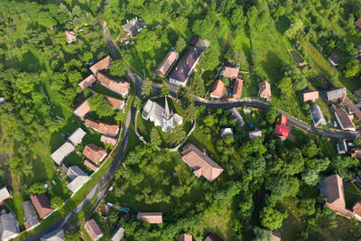Aerial drone point of view of a whitewashed protestant church in manastireni, transylvania, romania