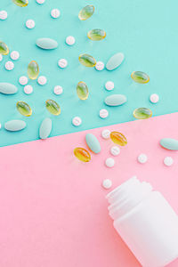 High angle view of pills against pink background