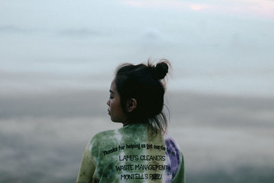 Portrait of woman standing against sky