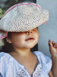 Portrait of young woman wearing hat