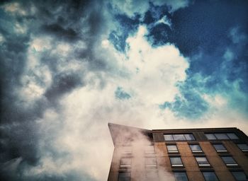 Low angle view of building against cloudy sky