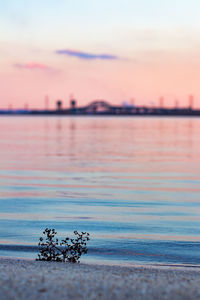 Scenic view of sunset over lake and bridge at horizon