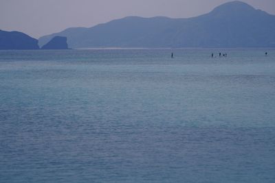 Scenic view of sea and mountains against sky