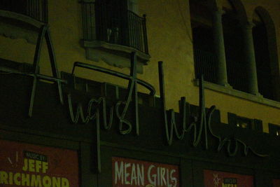 Low angle view of illuminated text on building