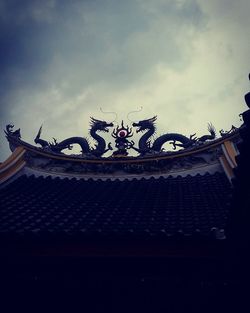 Low angle view of sculpture on roof