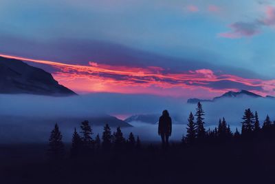 Scenic view of silhouette mountains against sky at sunset