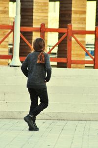 Full length of boy standing on slide