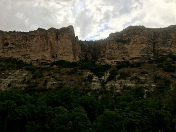 Low angle view of rock formations against sky