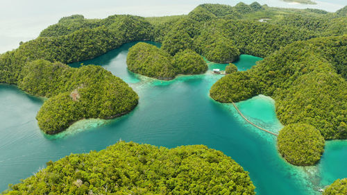 Turquoise waters of the sugba lagoon and islands covered with green forest and jungle. siargao