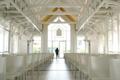 Rear view of man walking in corridor